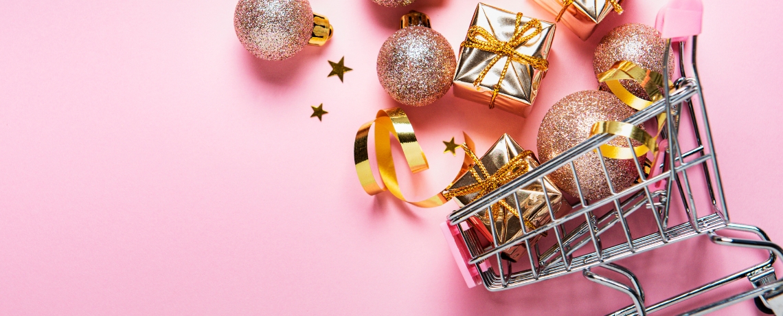 basket with holiday decor on pink background