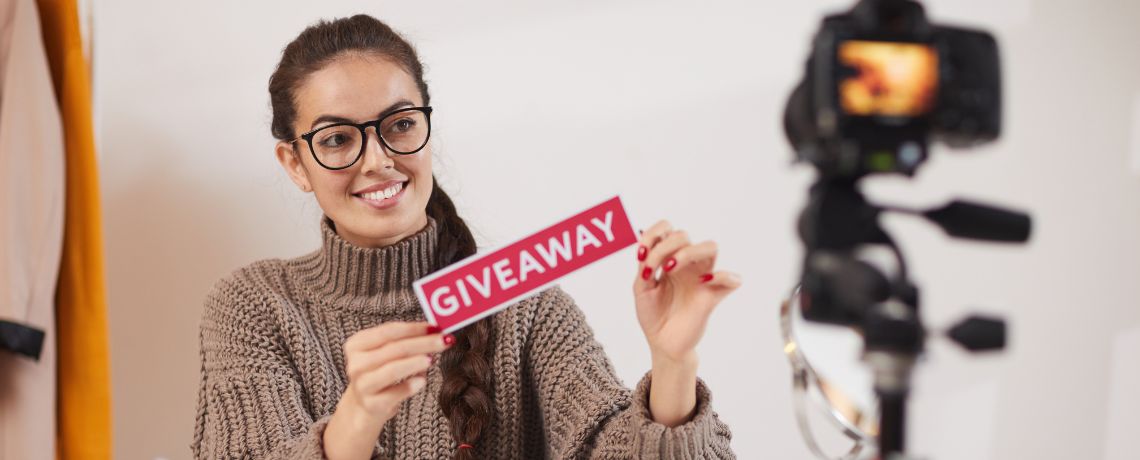 influencer holding giveaway sign