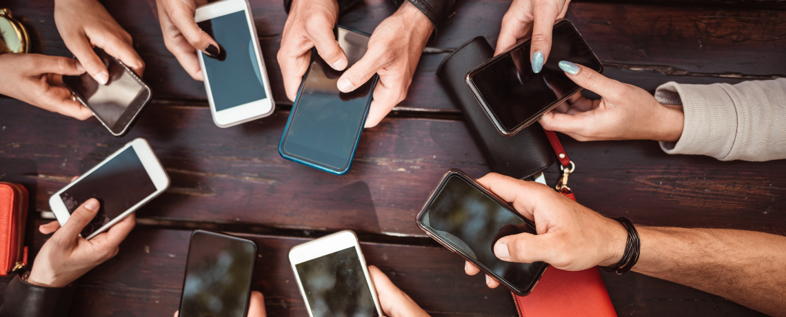 group of people holding smartphones