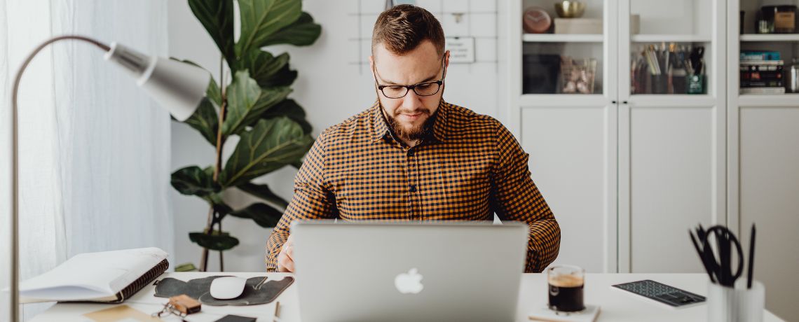 man working on laptop in home office