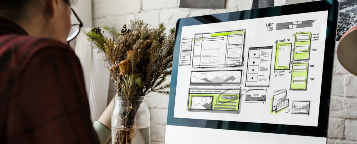 woman designing website on desktop computer
